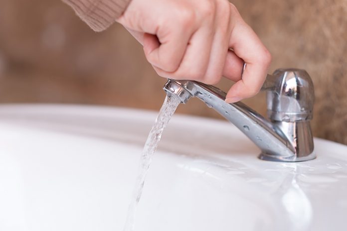 Close up hand open or close water tab . faucet and saving concep
