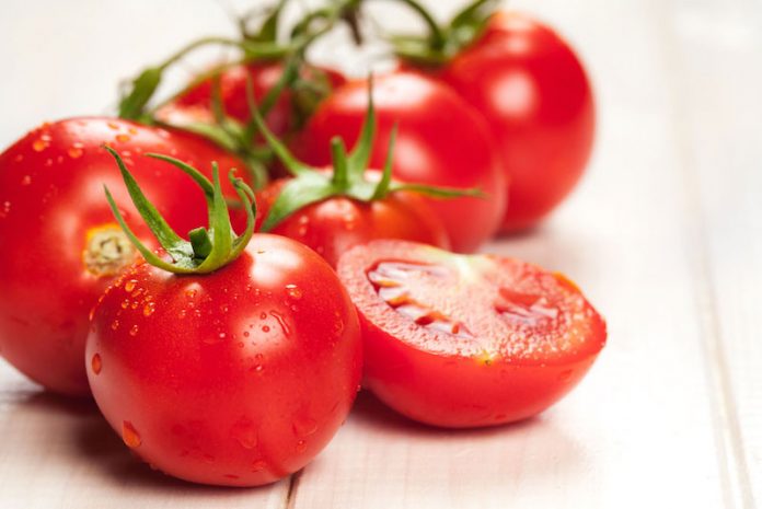 red tomatoes on wooden table
