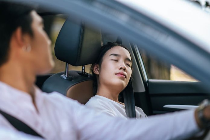 Women and men sit in cars and are stressed.