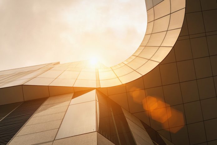 Low,Angle,View,Of,Modern,Golden,Architecture,Exterior,With,Curve