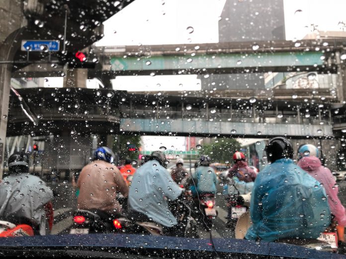 Motorists,Wearing,Raincoats,Waiting,For,Traffic